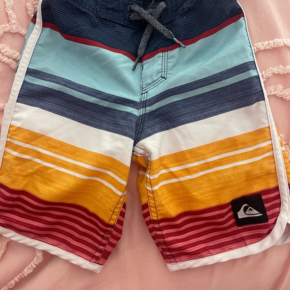 Quiksilver Blue and Red Surf Shorts with Striped Design